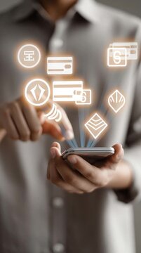 Digital Financial Interface: A close-up shot showcases a person interacting with a smartphone, digital icons representing currency, credit card, wallet, and payment processing light up.