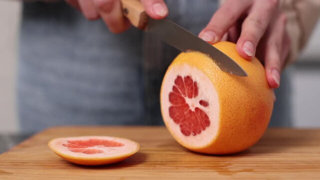 Enjoying fresh grapefruit preparation in a cozy kitchen setting