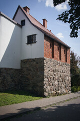 A brick building with a white roof and a window