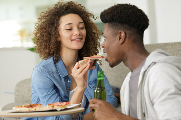 couple eating pizza snack outdoors