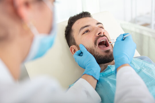man having teeth examined at dentists