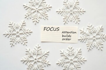 Flat lay of white snowflake cutouts arranged with focus in center