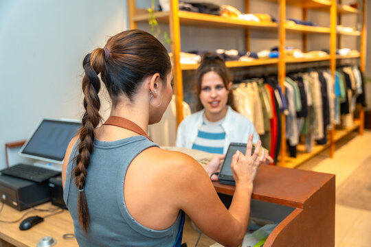 Customer paying with contactless payment in fashion store