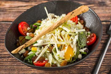 Fresh mixed green salad with parmesan cheese and breadstick
