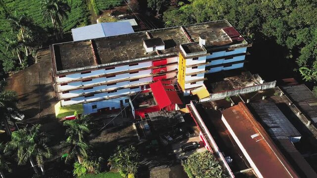 Aerial view of the Bois Cheri Tea Factory, where the building contrasts with the surrounding green tea plantations, Bois Cheri, Savanne District, Mauritius.