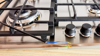 Intricate dance of disconnected wires and metallic burners; an ode to National Technology Day and Unplugged Kitchen Exploration April 5, 2025, Barcelona, Spain