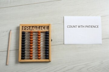 Wooden Abacus on a Light Wood Surface Demonstrating Arithmetic