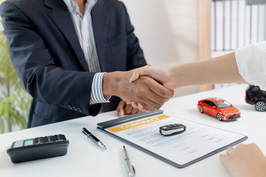 A professional car sales process showing contract signing, financial discussion, key handover, and handshake between client and dealer, symbolizing trust, agreement, and successful deal.
