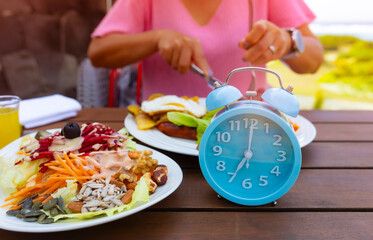Alarm clock with IF (Intermittent Fasting) 16 and 8 diet rule and weight loss concept.-Diet plan concept