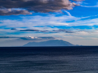 Samothraki island view, distant view of Samothraki island seen from the mainland across the Aegean Sea. Scenic seascape and horizon landscape.