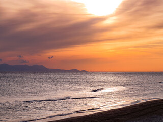  Sunset and seascapes , beautiful sunset seascape with dramatic clouds, calm waves, and rocky coastline. Scenic view of the ocean horizon and natural evening light.