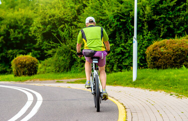 Fototapeta premium Cyclist ride on the bike path in the city Park 