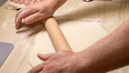 Gentle hands of a Caucasian man wielding a rolling pin evoke Fiesta del Pan, celebrating doughs poetic dance April 5 2025, Barcelona, Spain