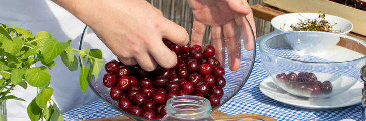 A hand dives into glistening cherries, evoking Midsummer feast, Scandinavian culinary rituals, tart juiciness celebration April 5 2025, Barcelona, Spain