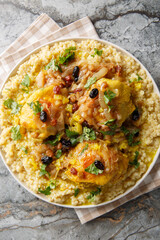 Moroccan Tfaya Couscous With Braised Chicken closeup on the plate on the table. Vertical top view from above