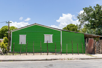 Pedernales, Dominican Republic, 8 august 2025. Typical Dominican Caribbean house made of wood, painted a bright green color.