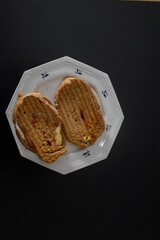 Sandwiches made of homemade bread toasted with ham, spreadable cheese and ketchup inside. Homemade food that is always good to start or end the day.