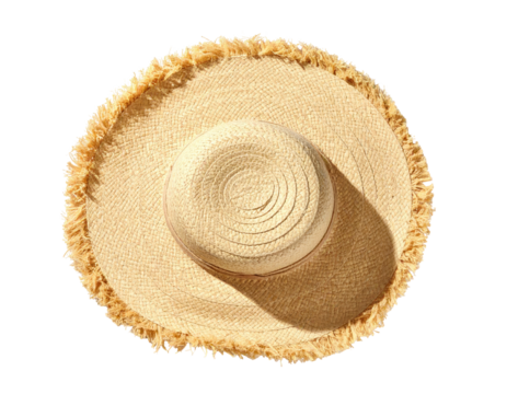 Overhead view of a straw hat with a fringed brim casting a shadow