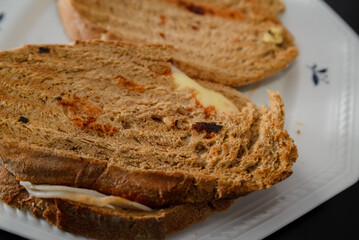 Sandwiches made of homemade bread toasted with ham, spreadable cheese and ketchup inside. Homemade food that is always good to start or end the day.