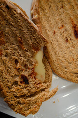 Sandwiches made of homemade bread toasted with ham, spreadable cheese and ketchup inside. Homemade food that is always good to start or end the day.