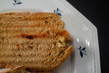 Sandwiches made of homemade bread toasted with ham, spreadable cheese and ketchup inside. Homemade food that is always good to start or end the day.