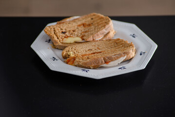 Sandwiches made of homemade bread toasted with ham, spreadable cheese and ketchup inside. Homemade food that is always good to start or end the day.