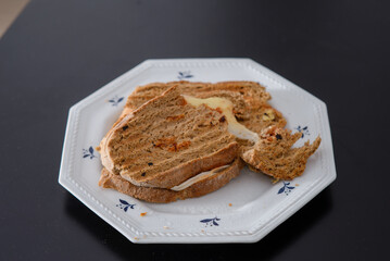 Sandwiches made of homemade bread toasted with ham, spreadable cheese and ketchup inside. Homemade food that is always good to start or end the day.