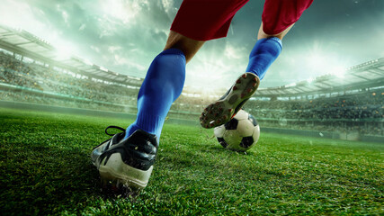 Faceless soccer player in red shorts and blue socks kicking ball on illuminated 3D stadium grass. Concept of teamwork, national pride, sports branding, campaigns and competition highlights.