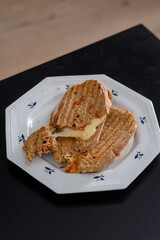 Sandwiches made of homemade bread toasted with ham, spreadable cheese and ketchup inside. Homemade food that is always good to start or end the day.