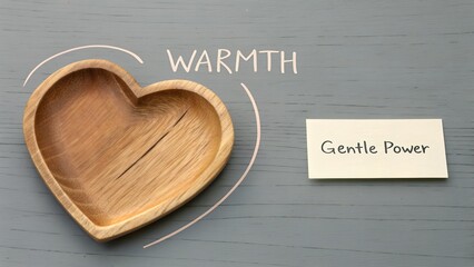 Wooden heart shaped bowl next to gentle note