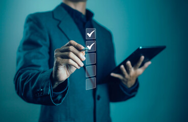 Businessman checking digital checklist with pen and tablet. Concept of productivity, project management, business strategy, technology solutions and successful workflow in modern organization.