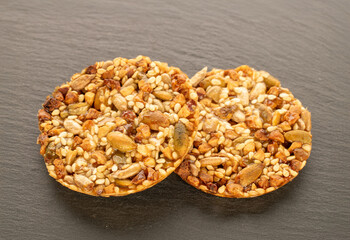 Thaler cookies with nuts and honey, on a slate stone, close-up.