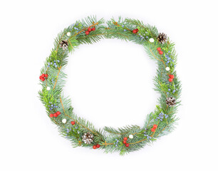 A Christmas wreath of fir branches decorated with berries, isolated on a white background. A Christmas design element.
