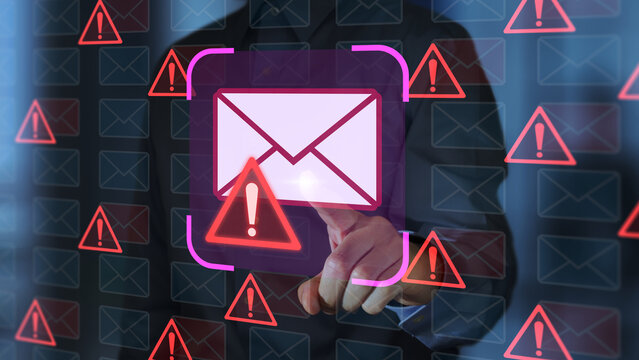Email security software detecting phishing or scam mail and displaying warning alert. Business person touching email icon to delete malicious emails.