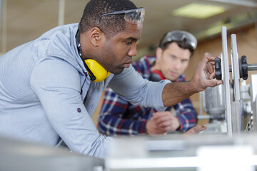 carpenter with apprentice in training period