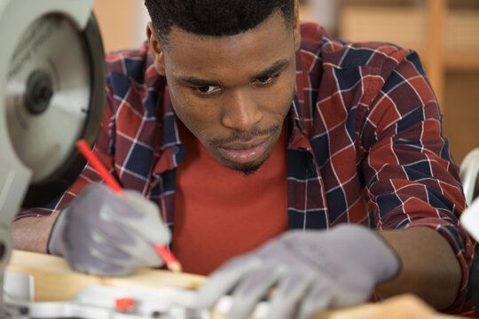 serious and concentrated carpenter marking position on wood
