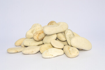 A pile of white pebbles on a white background. A background for a banner, backdrop, or texture for 3D mapping.