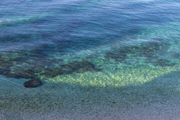 Rippling sea surface and rocky bottom of the Adriatic Sea. Marine background. Copy space.