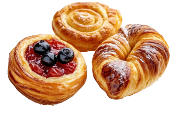 Delicious pastries including a fruit danish cinnamon roll and croissant isolated on transparent background. Danish pastry isolated on white background.