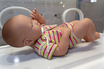 Mannequin infant in an incubator