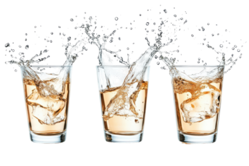 Glasses of whiskey splashing isolated on transparent background. Glasses shot of tequila making toast with splash isolated on white background.