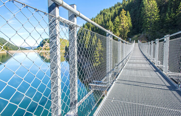 metal walkway crossing the lake saint gu&eacute;rin in the massif of beaufortain in the French Alps