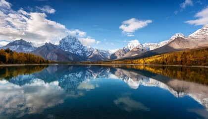 Fototapeta premium Majestic Mountain Range Reflected In A Calm Blue Lake Under A Cloudy Sky Mountains Reflection