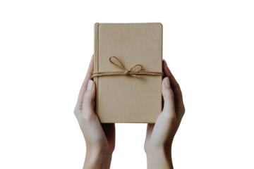 Hands holding a rustic gift box tied with twine isolated on transparent background. Hands holding closed book mockup isolated on white background.