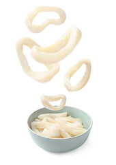 Fresh squid rings falling into bowl against white background