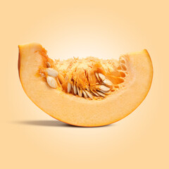 Slice of ripe pumpkin on dark beige background