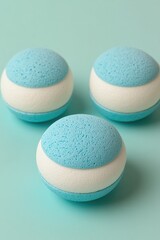 Obraz premium Three blue & white bath bombs on light blue background