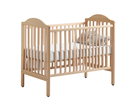 A wooden crib with a mattress and pillow, against a dark background