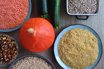 Assortment of various healthy fruits, vegetables, grains and legumes. Top view, wooden background.