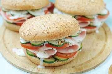 Bun sandwiches with salami and vegetables	